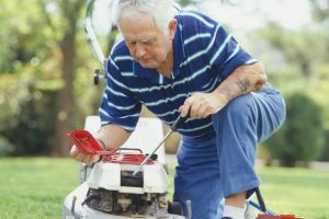 Man fixing lawn mower